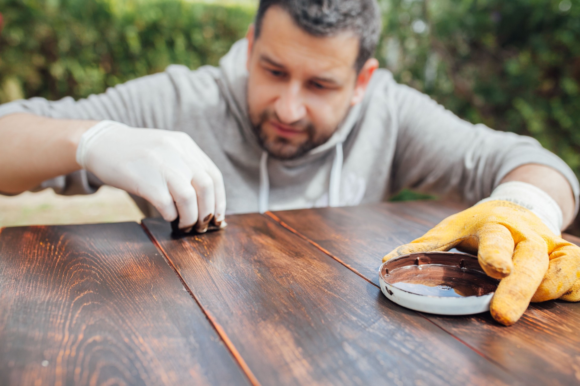 Expert polishing and surface repair on a wooden table.